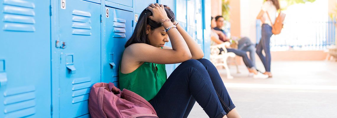 Sad girl in college corridor