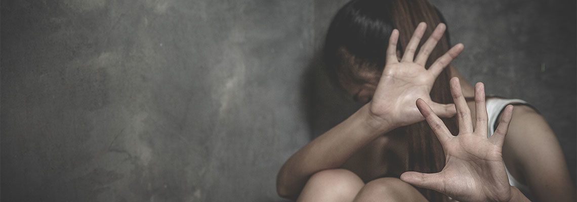 Scared women sitting in corner