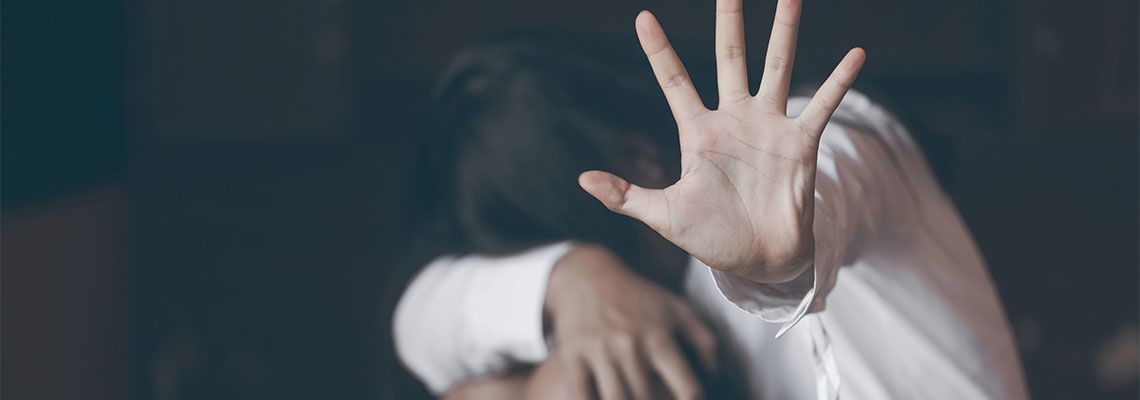 Women showing hands signaling to stop sexual violence