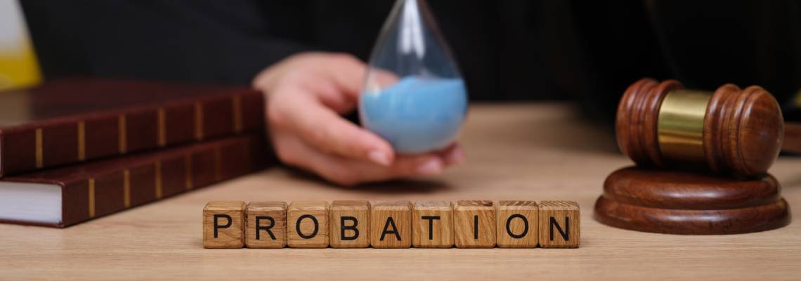 Wooden blocks with word Probation, gavel and judge holding hourglass