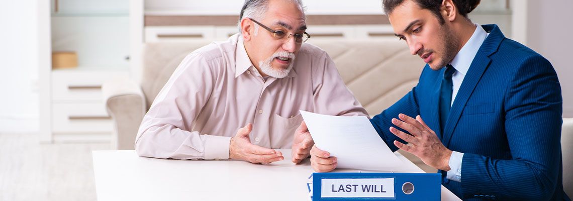 Young male lawyer visiting old man to revise his will
