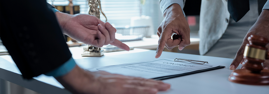 Legal professionals examining contract provisions