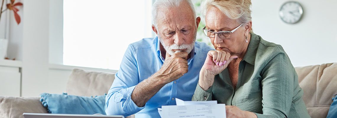 Confused couples looking at financial statement