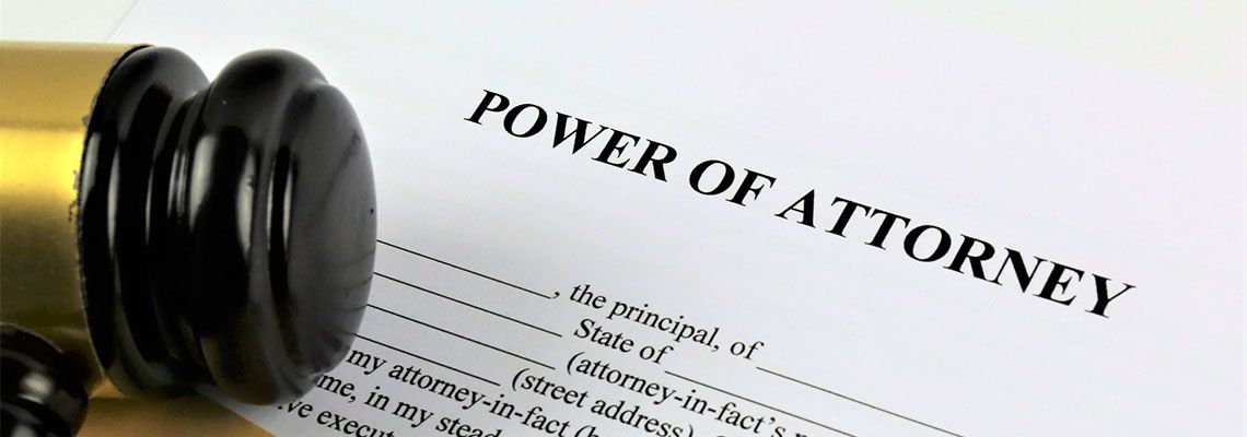 Power of Attorney file and gavel on table