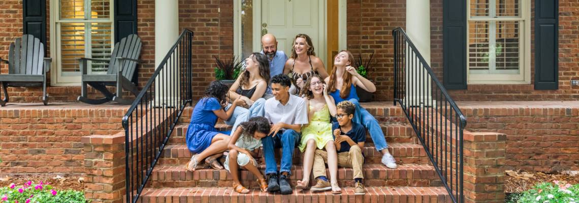 Large and Mixed family on the front steps
