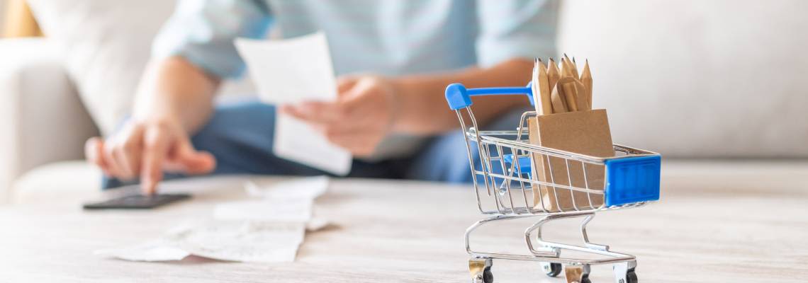 Person using a calculator and receipts to manage finances