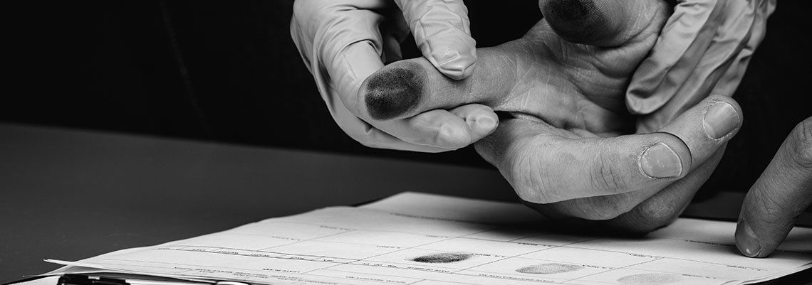 Police taking fingerprints of a man