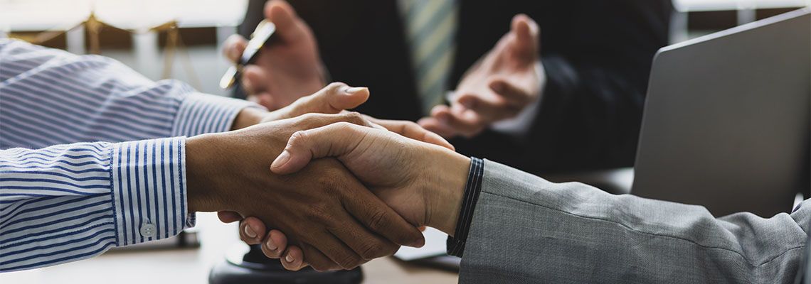 Businessman shaking hands after successful mediation