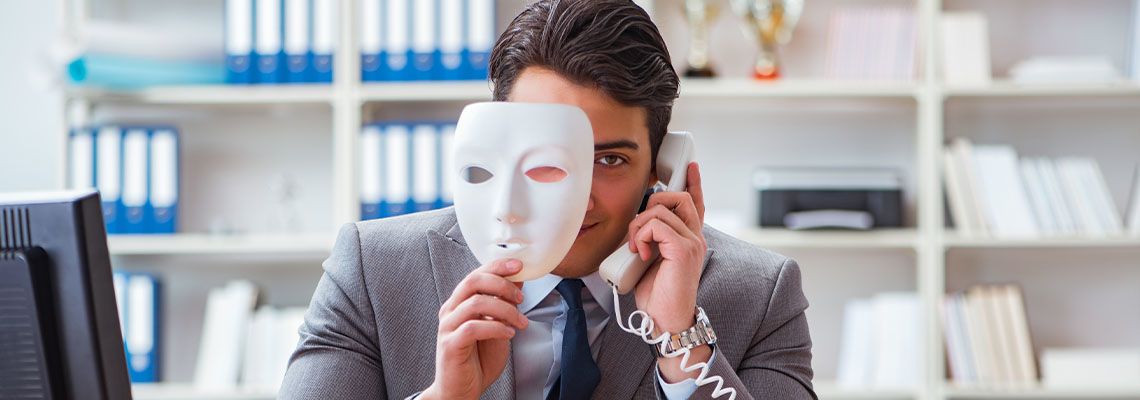 Businessman with fake mask in office
