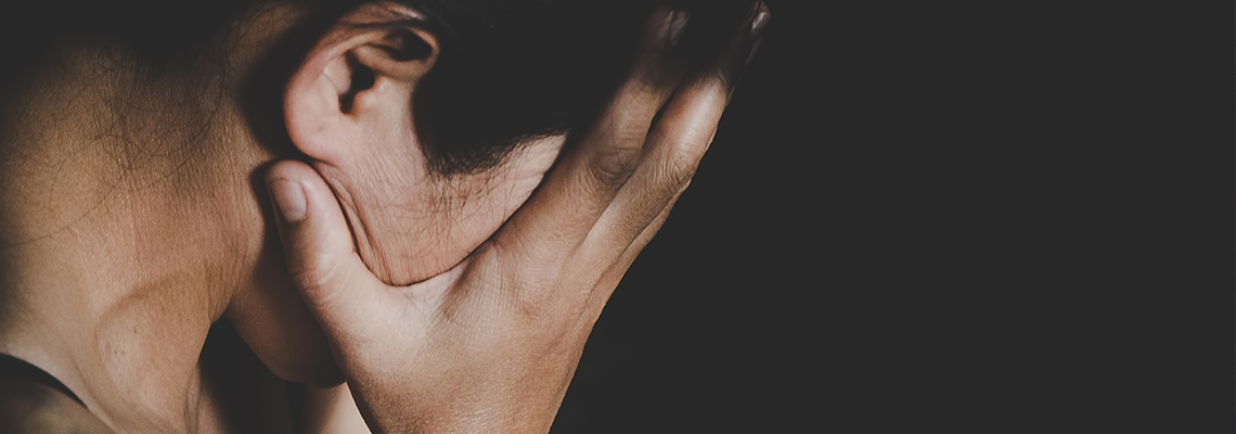 Close up of a woman with head in her hands
