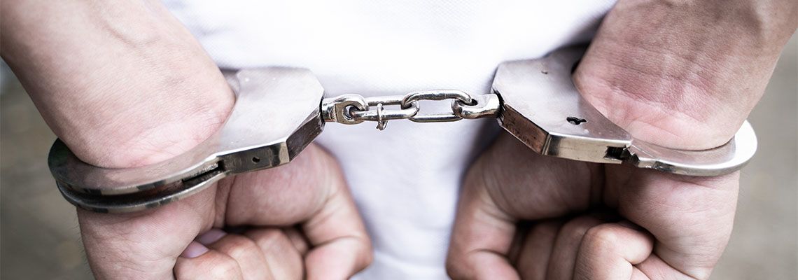 Male hands arrested with handcuffs