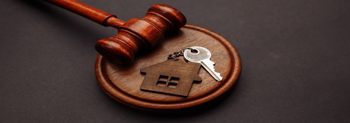 Gavel resting near house keys