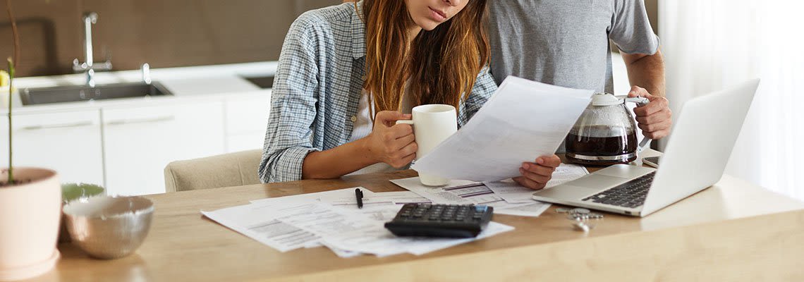 Couple looking over documents in their home