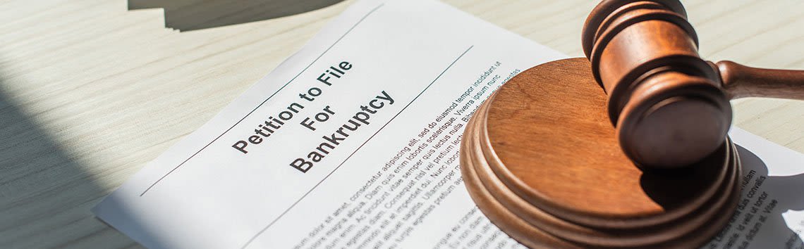 Documents that say "Petition to File For Bankruptcy" with a gavel