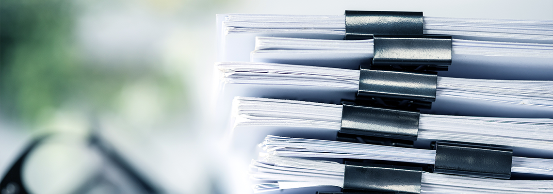 Stack of paperwork organized in binder clips