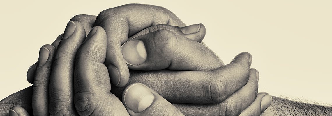 A family holds hands