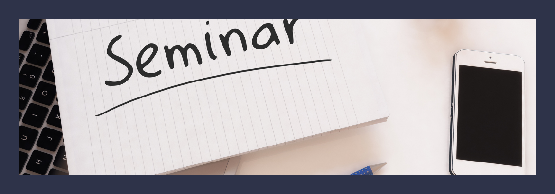 Seminar written on a notepad next to a cellphone