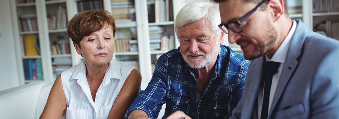 Senior couples preparing legal documents with the help of an attorney