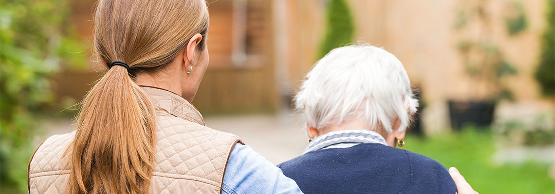 Daughter taking care of elderly parent