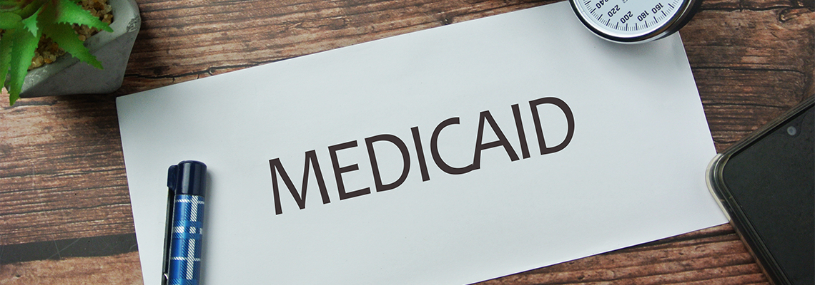 Pen, spectacle and notebook written with MEDICAID