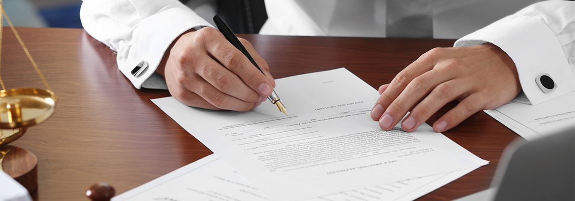 Lawyer in office signing document