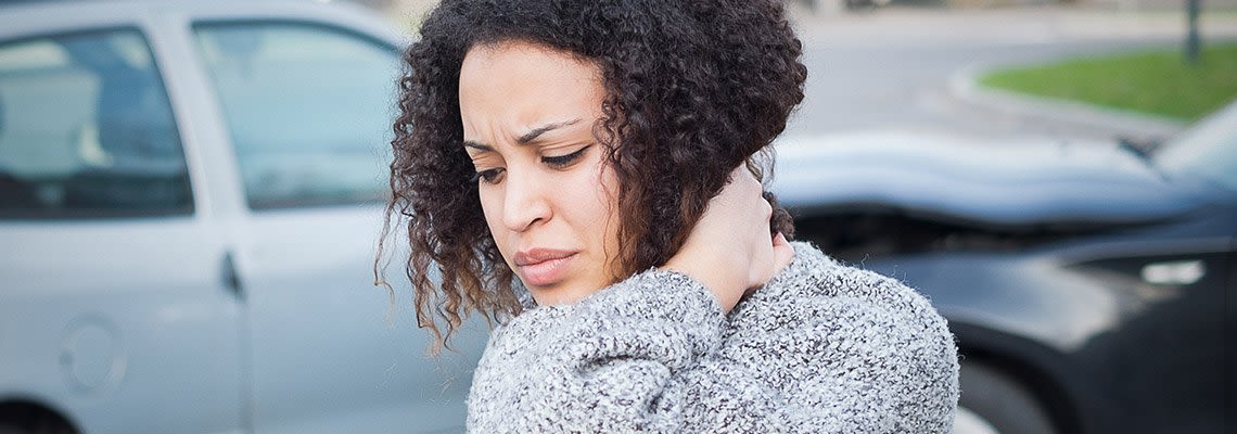 Woman holding her neck in pain after a car accident