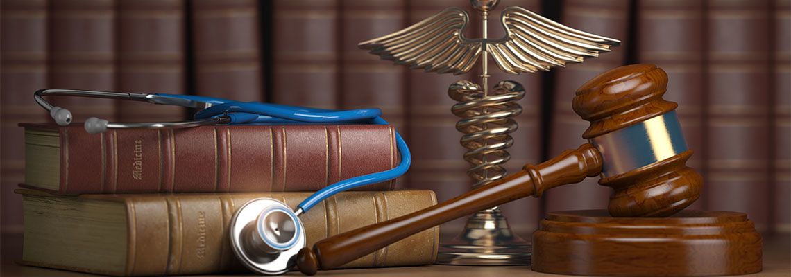 Gavel, stethoscope, books and caduceus