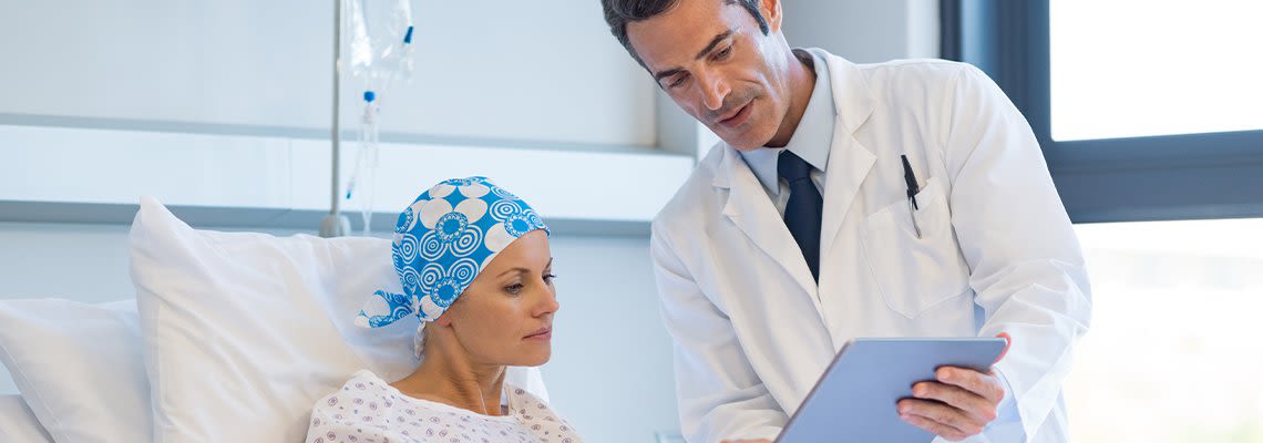 Doctor with Pointing at Clipboard with Patient