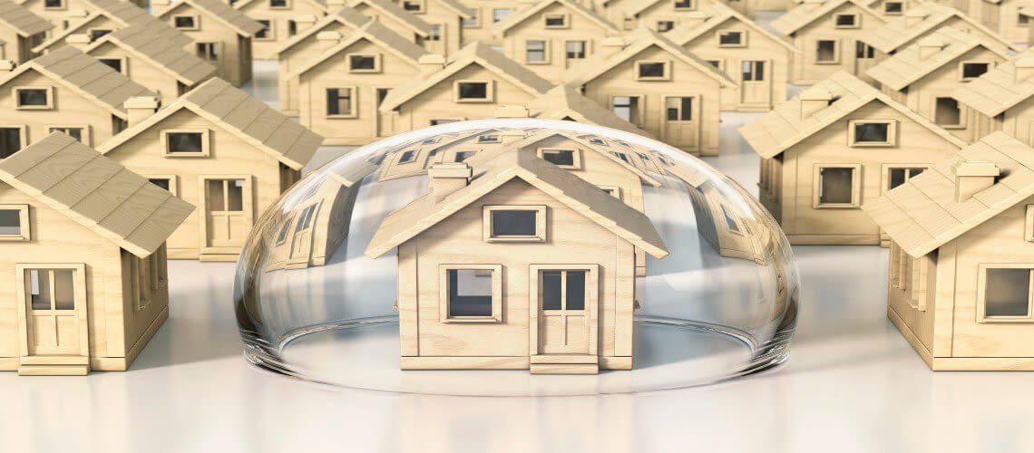 A group of tiny wooden homes with one in the center inside a bubble