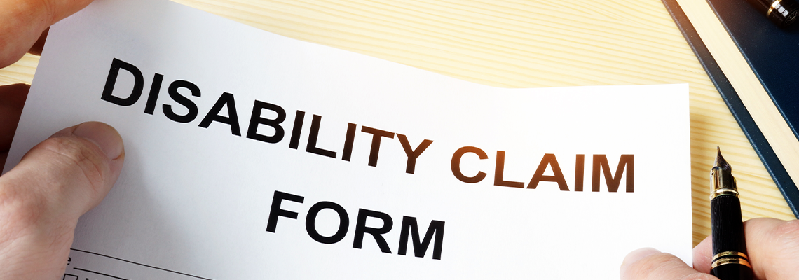 Man Holding Disability Claim Form for Insurance