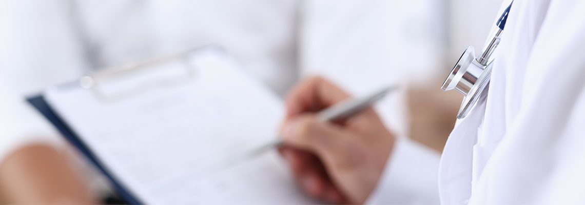 IME Physician Preparing Report After Examining Injured Person