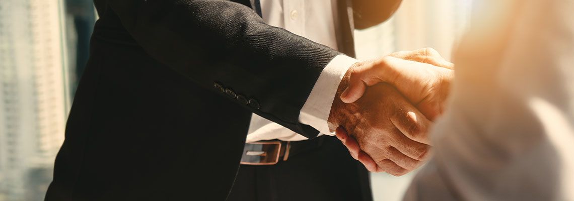 Businessmen shake hands after reaching an agreement