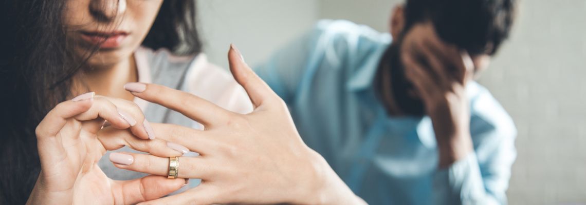 Women removing wedding ring from hand
