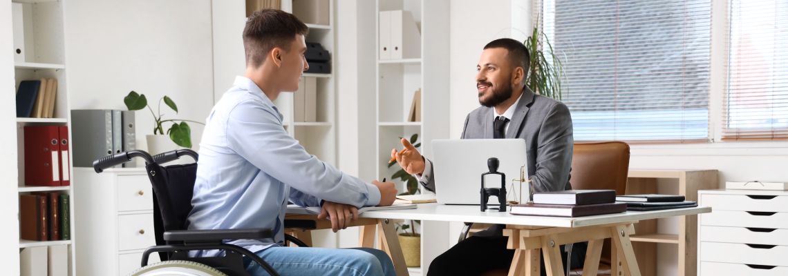 Man in wheelchair consulting with attorney