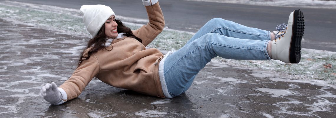 Women slip and fall in icy pavement