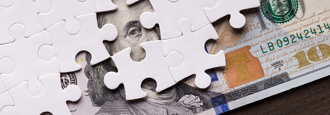 American Dollar Hidden Under Puzzle Pieces