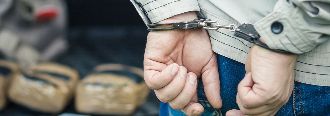 Man in handcuffs detained for transportation of drugs