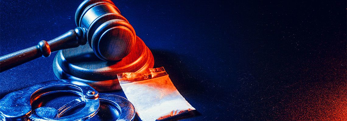 Gavel, Drugs and Handcuffs on table