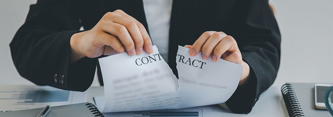 Business women tearing contract papers