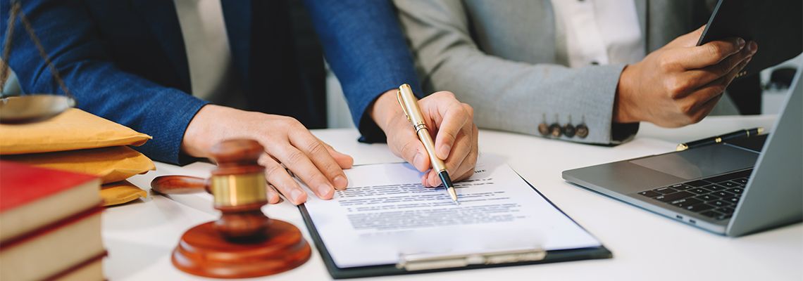 Businessman and attorney discussing contract papers