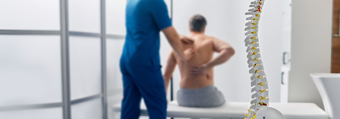 Doctor treating patient with spinal cord injury