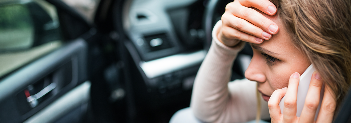 Young Woman in The Damaged Car After a Car Accident Making Call
