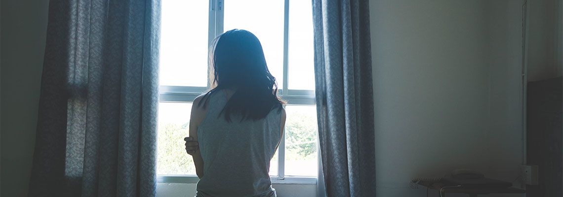 Women sitting in dark corner, concept of sex abuse