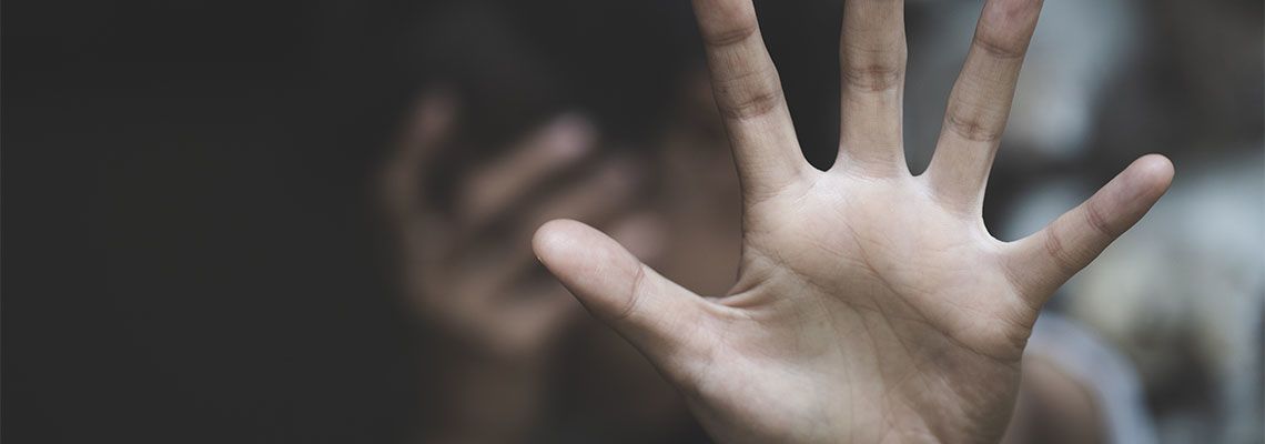 Women showing hand as a gesture to stop sexual abuse