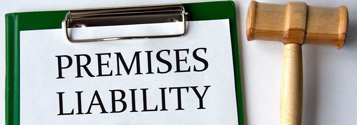 Premises Liability words on paper with gavel on table