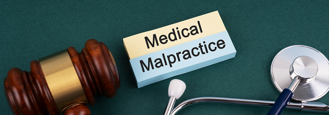 High angle view of gavel and stethoscope Medical Malpractice concept