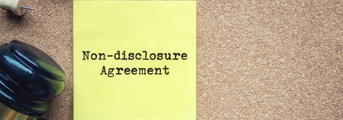 Gavel and Non-Disclosure Agreement Text on sticky note
