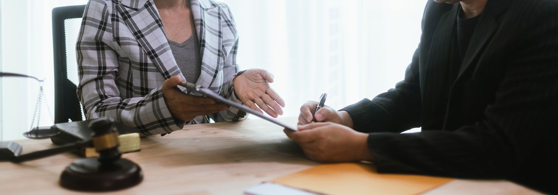 Businessman and attorney discussing contract terms