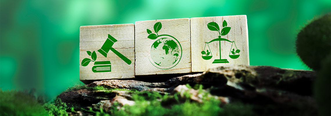 Sustainable law and eco justice icons on wooden cubes over green forest background