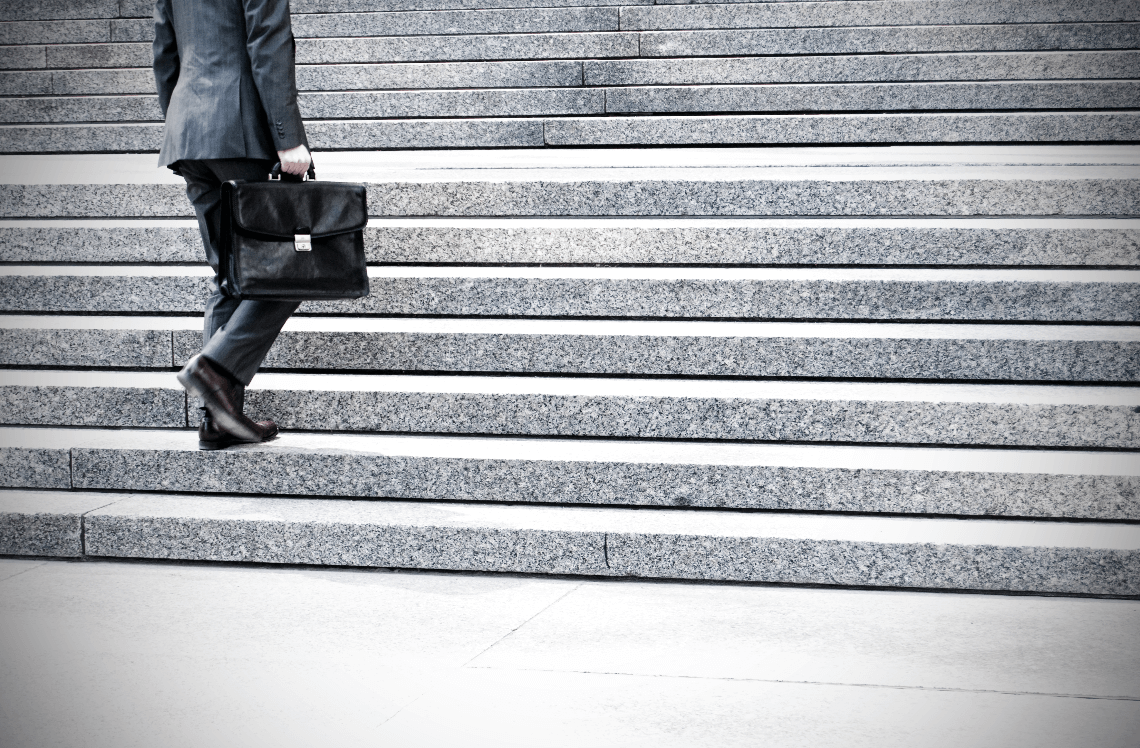 Man in Suit Walking Up the Stairs